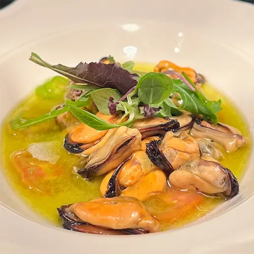 Cozze in guazzetto con insalatina fresca, piatto di cucina di mare del bistrot